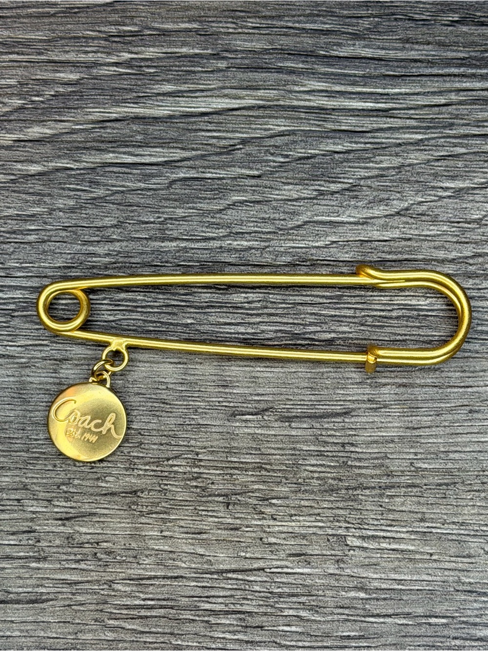 Coach Gold-Tone Safety Pin Brooch with Round Logo Charm